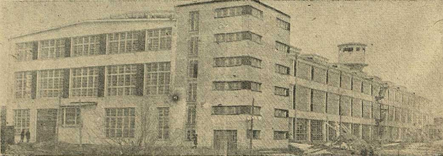 Schwarze und weiße Fotografie eines großen Gebäudes mit der Aufschrift "New York Post Office", umgeben von Bäumen und einem klaren Himmel.