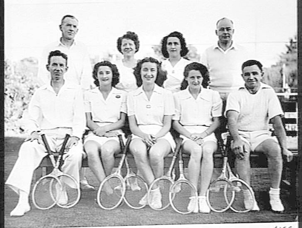 Schwarzes Foto einer Gruppe von Menschen auf einer Bank sitzend, die lächeln und Tennisrackets halten, mit Bäumen und einem klaren Himmel im Hintergrund, Text unten lautet "Tennis Hall of Fame".